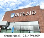 Small photo of Los Angeles, CA - June 8, 2023: Closeup of Rite Aid pharmacy and convenience market, with newer logo on brick wall.