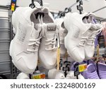 Small photo of Los Angeles, CA - June 20, 2023: White pairs of Madden NYC womens shoes on display at a Walmart store.