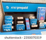 Small photo of Los Angeles, CA - August 11, 2023: eSim and ATT Prepaid phone cards on display stand inside a department store.