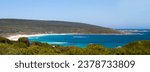Small photo of Tide ebbing out from the famous white sandy surfing beach and rocky shore at Margaret River, South Western Australia on a calm clear sunny afternoon in early summer creates a scenic seascape.