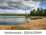 Landscape with sandy lake shore on a summer day.