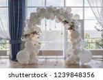 an arch of white balloons .
festive decor for the wedding.
decor of balloons and lights.
wedding background.
place of the wedding ceremony