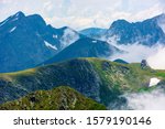 peaks of mountain ridge above the clouds. gorgeous scenery of romanian mountains. fagaras massif in summertime