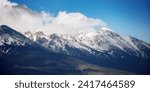 Small photo of nature background of mighty high tatra ridge in spring at high noon. snow capped rocky peaks of slovakia beneath a cloudy sky