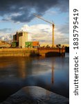 Small photo of Boston Lincolnshire UK. October 6 2020: A HAWKS Construction crane by the flood barrier on the river Haven Witham)