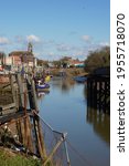Small photo of The River Witham in the spring sunshine with fishing boats and the Stump in the background. Boston Lincolnshire UK April 2021