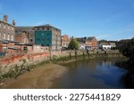 Small photo of Old buildings down South Street on the river Haven (Witham) at low tide in the summer during the pandemic in 2020