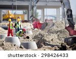 Small Excavator And Workers At...