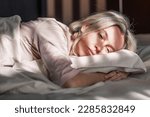 Small photo of Stressed middle aged woman lying on bed at home and crying. Unhappy woman suffering from nervous tension, emotional disorders, psychological problems, breakup. Frustrated female feeling lonely