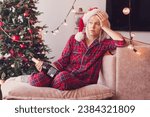 Sad lonely woman complaining in Christmas sitting on a couch in the living room at home