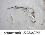 Small photo of White paint peeling due to wetness in the building. Peeling off paint on the wall. Visible brown coating, inaccurate fix.