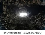 Small photo of Underground mining, tunnel in the rock. There is a bright light at the end of the tunnel