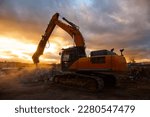 Small photo of Powerful crusher destroys armored cement leftovers at sunset