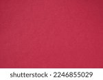 Closeup photo of cardboard sheet surface in magenta red color. Unicolor background.
