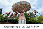 Small photo of West Mifflin, Pennsylvania, USA - June 30, 2023: Visitors to Kennywood Park near Pittsburgh have fun enjoying the "Wave Swinger" ride on a hot, summer afternoon.
