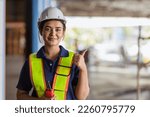 Small photo of Indian woman staff worker engineer supervisor in safety suit work in factory warehouse