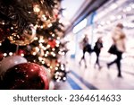 Christmas rush, Christmas lights with  silhouettes of defocused shoppers in a shopping mall