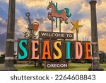 Colorful Seaside Oregon coastal town welcome sign featuring city