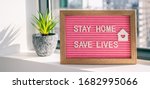 Small photo of COVID-19 Coronavirus "STAY HOME SAVE LIVES" viral social media message sign with text for social distancing awareness. COVID-19 staying at home concept. Flatten the curve.