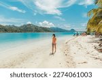 Small photo of French Polynesia Travel beach picnic motu tour on Huahine, Tahiti, French Polynesia. Happy tourist woman walking on perfect beach living healthy lifestyle