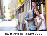 San Francisco city tourists riding cable car tramway tourism people lifestyle. Young interracial couple enjoying ride of cable car railway system, popular travel attraction.