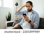 Sad man checking smartphone...