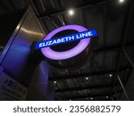 Small photo of LONDON, UK - OCTOBER 2022: Elizabeth Line tube station roundel at night