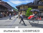 Small photo of Takayama, Japan - 5 June 2017 : Jinrikisha or Japanese rickshaw driven by male driver carrying women tourist for sightseeing in historical city Takayama in Japan. This place is main travel attraction