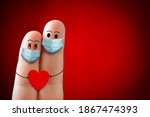 A happy finger couple in love with protective mask Valentines Day during covid 19 coronavirus. New Normal
