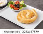 Small photo of Traditional Turkish pastry made with spinach and cheese wrapped in phyllo. Turkish name gul boregi or gul borek