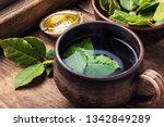 .Delicious herbal tea with bay leaf on wooden background