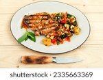 Small photo of Grilled tunny steak with baked vegetables on a plate. Keto diet