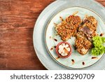 Small photo of Steak of baked tuna or tunny in a nut panic with a mangosteens on rustic wooden table. Copy space.