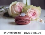 diamond ring on macaron and roses background