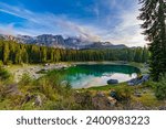 Lago di Carezza, an alpine marvel with emerald waters, cradled by spruce trees, framed by the majestic Dolomites, a fairy tale woven into nature's enchanting panorama