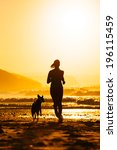Woman And Dog Running On...