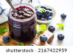 Small photo of Blueberry jam in the glass jar with fresh berries.