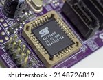 Small photo of Sochi, Russia - April 14 2022: SST flash chip of SST or Silicone Storage Technology company in socket of PC motherboard. Change or rewrite flash chip of pc motherboard in repair service.