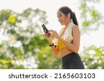 Small photo of sport active asian female sport cloth setting up smartphone playing prepare for her running routine workout morning healthy lifestyle,smiling sport woman setting runing route in her application map