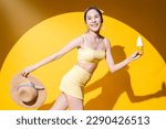 freshness delightful summer vacation people concept,asia adult woman in swimwear enjoy movement walking hand hold sunday soft serve icecream sweet desert smiling cheerful shooting on yellow background