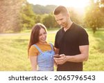 smiling young couple using... | Shutterstock . vector #2065796543