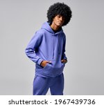 Small photo of Portrait of black man in track suit with circle afro hair